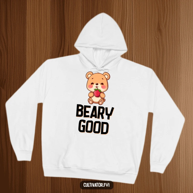 Funny hoodie with a playful bear character proudly presenting a single berry, offering warmth and a touch of pride.